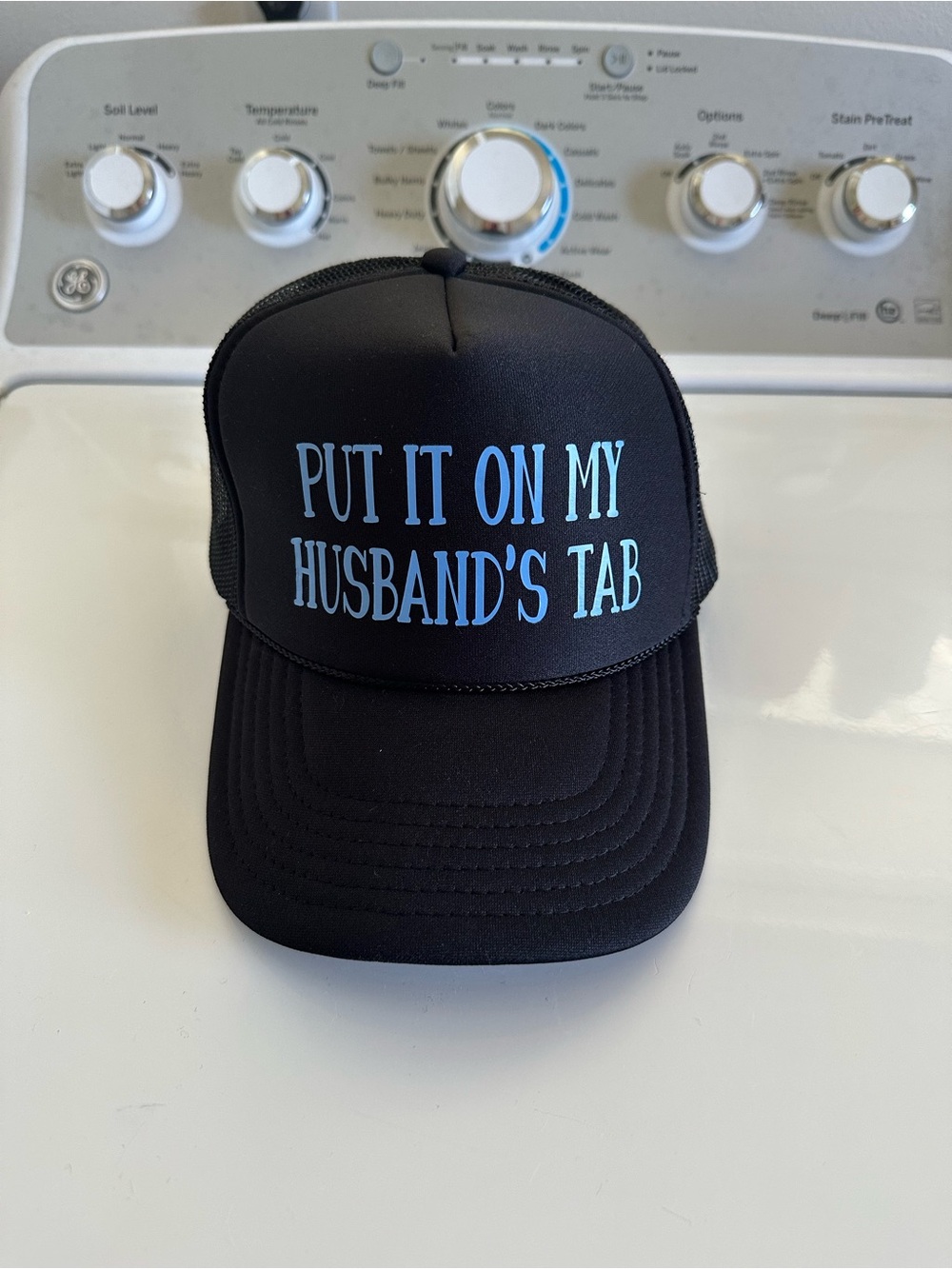 Put It On My Husband's Tab Black Trucker Hat